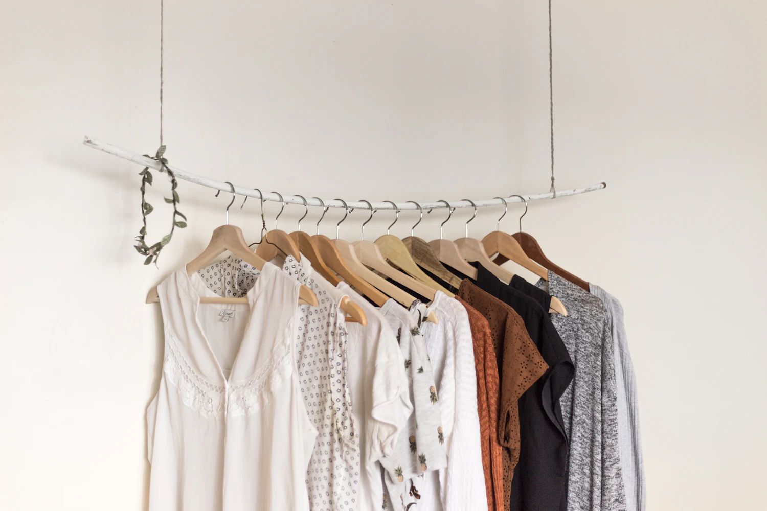 Neutral clothes arranged on a wardrobe rail